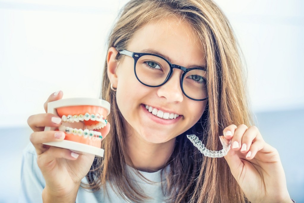 woman holds orthodontic materials